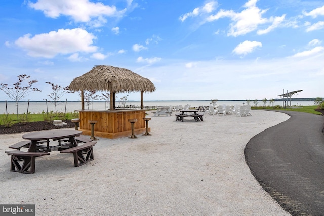 view of community featuring a bar and a water view