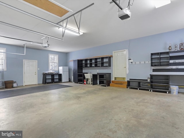 garage with a garage door opener and white fridge