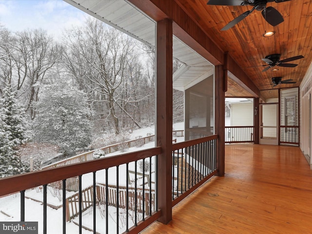 snow covered deck with a sunroom and ceiling fan