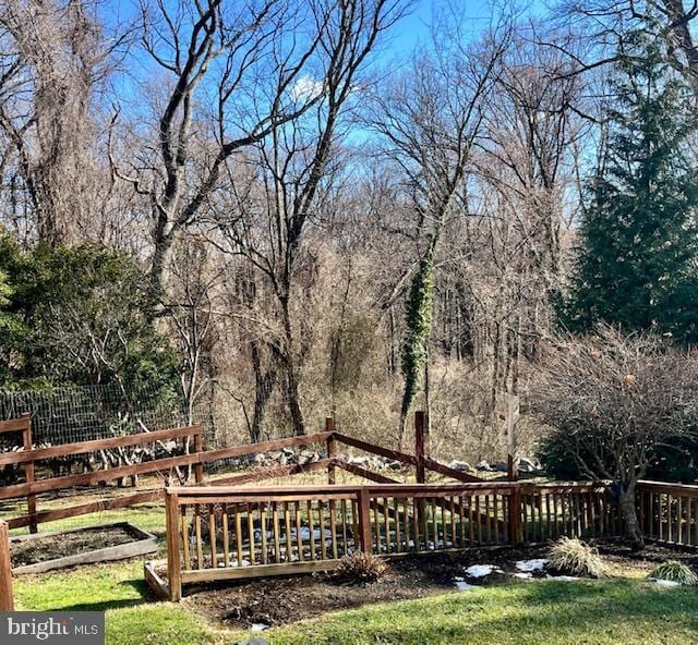 wooden deck featuring a lawn