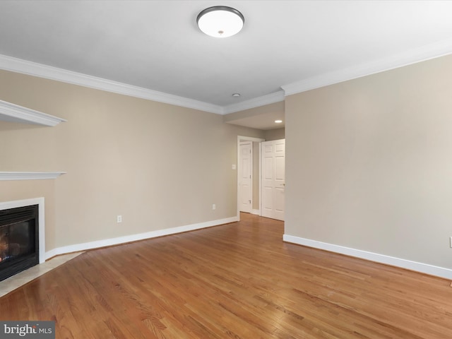 unfurnished living room with hardwood / wood-style flooring and ornamental molding