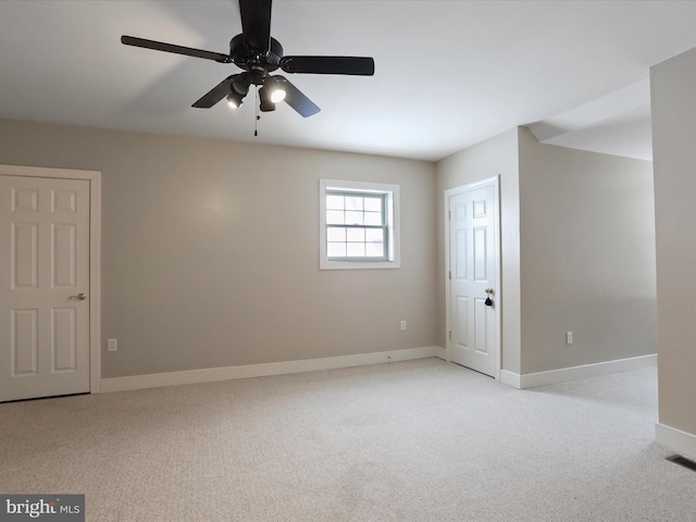 carpeted empty room with ceiling fan