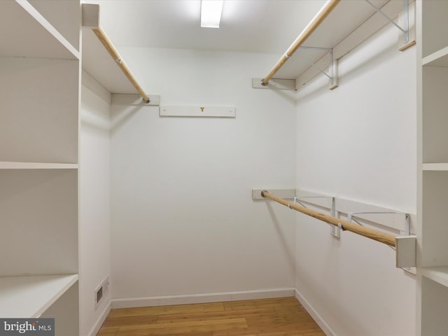 spacious closet featuring hardwood / wood-style floors