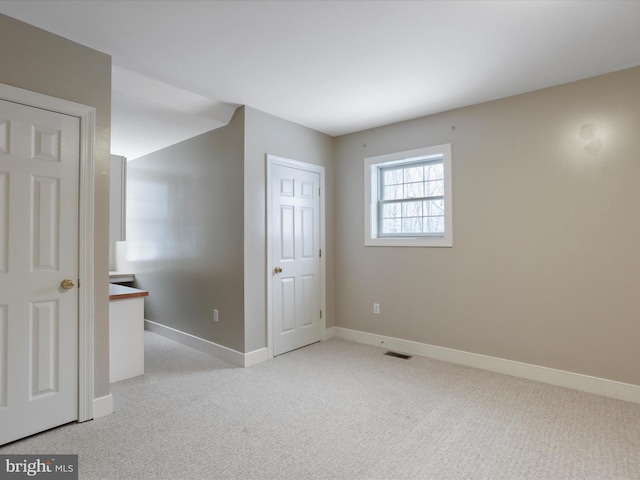 empty room featuring light carpet