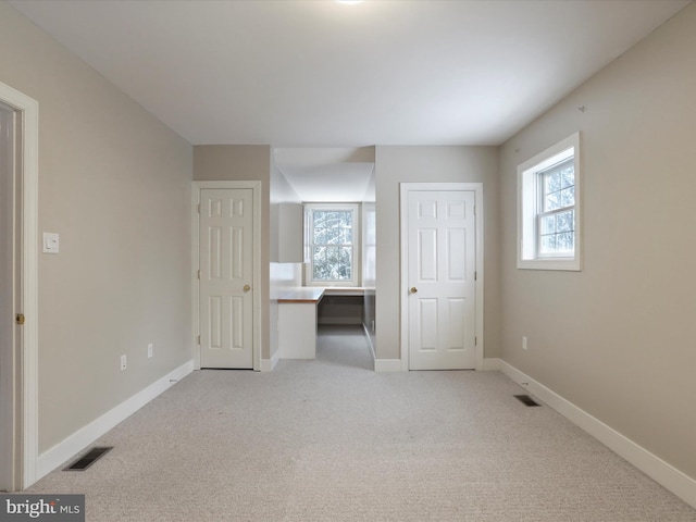 unfurnished bedroom with light carpet