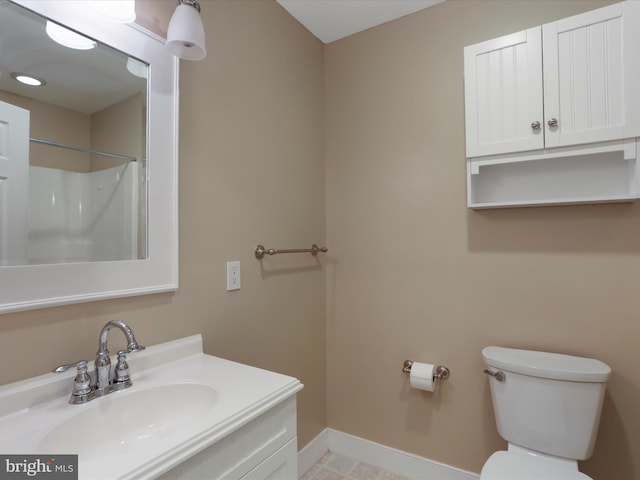 bathroom featuring a shower, sink, and toilet