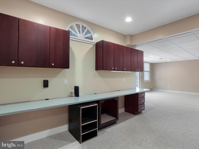 kitchen featuring light carpet and built in desk