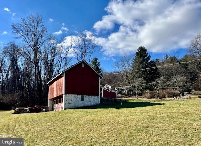 view of outbuilding with a yard