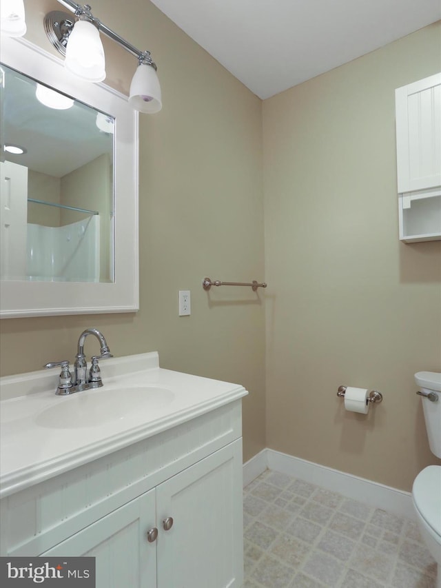 bathroom featuring vanity and toilet