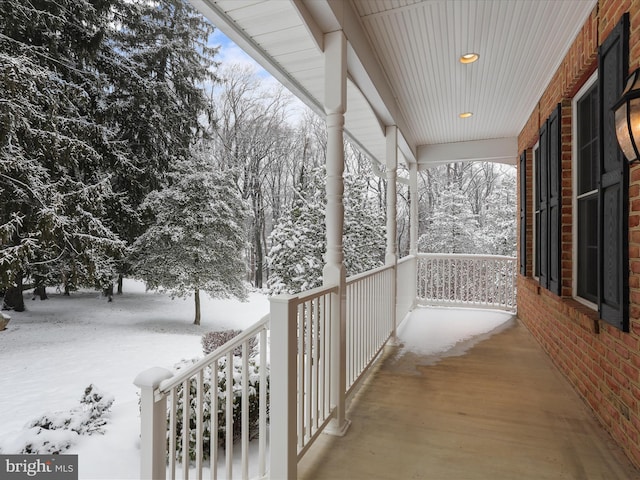 view of snow covered back of property