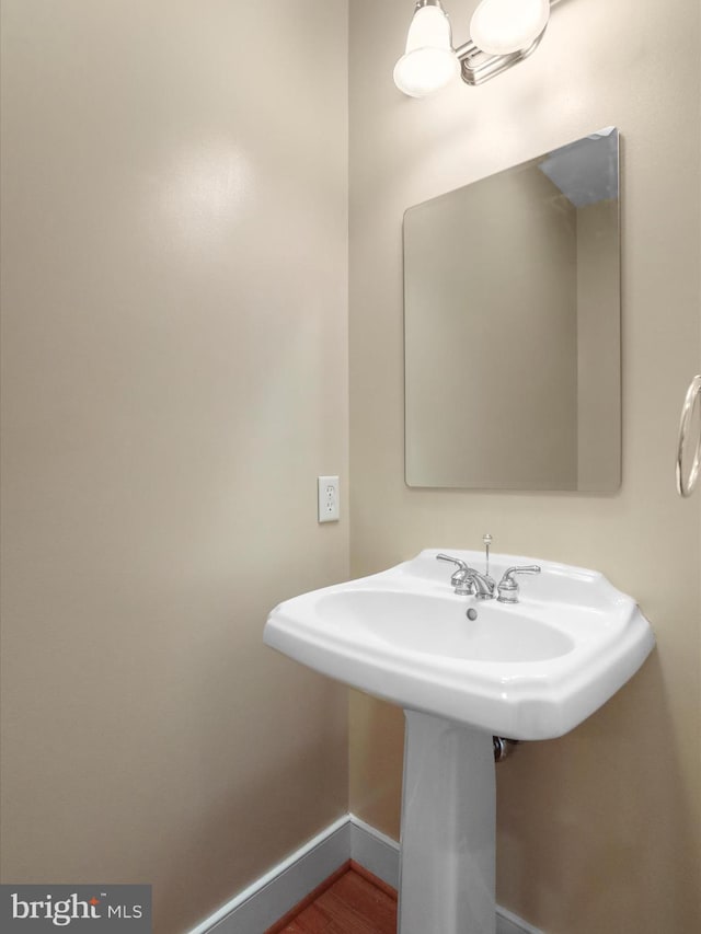 bathroom with hardwood / wood-style floors and sink