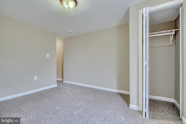 unfurnished bedroom featuring carpet and a closet