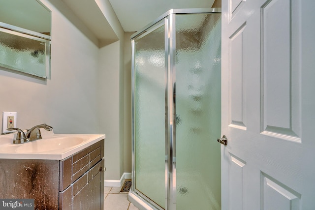 bathroom featuring sink, a shower with door, and tile patterned floors