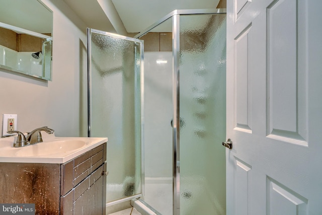 bathroom featuring vanity and an enclosed shower