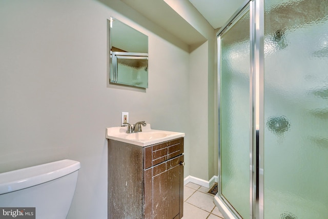 bathroom with an enclosed shower, vanity, tile patterned floors, and toilet