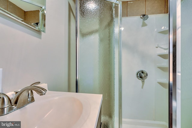 bathroom featuring vanity and a shower with door