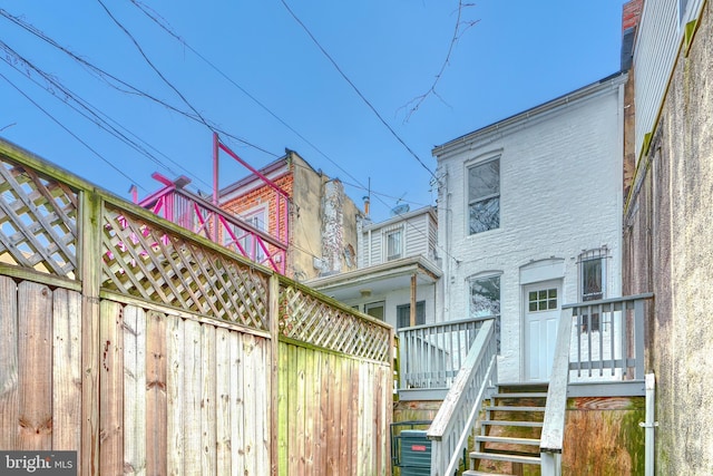 rear view of property featuring central air condition unit