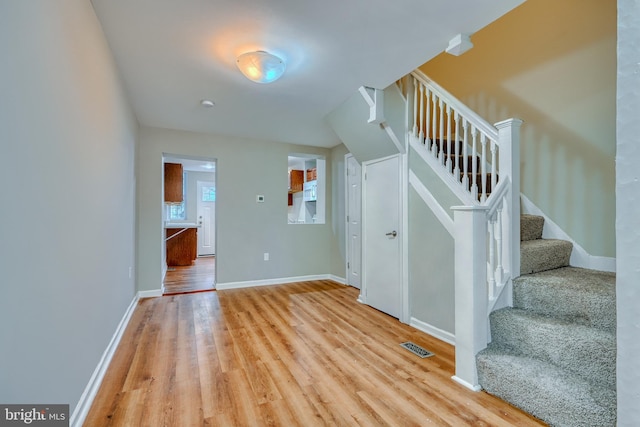 stairs featuring wood-type flooring