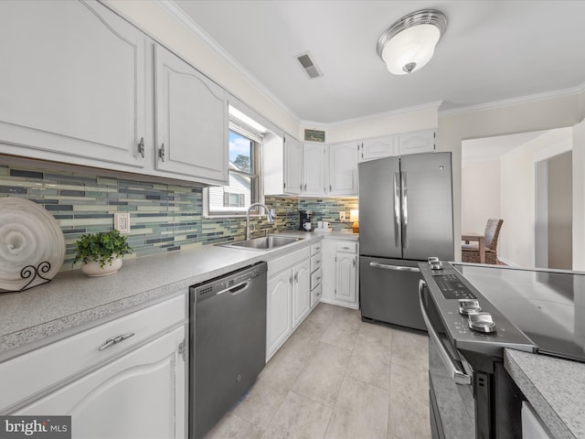 kitchen featuring crown molding, appliances with stainless steel finishes, sink, and white cabinets