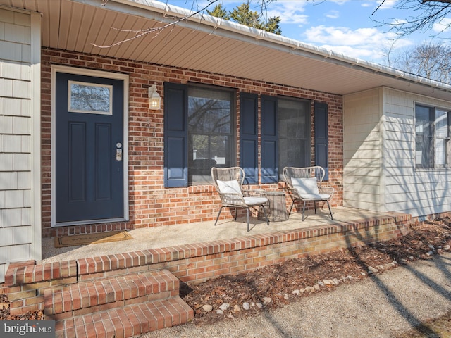 view of exterior entry with a porch