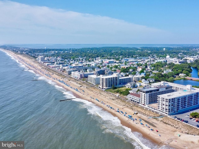 drone / aerial view featuring a water view and a beach view