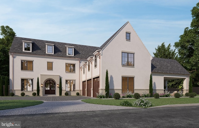 view of front of property featuring a garage, a front lawn, and french doors