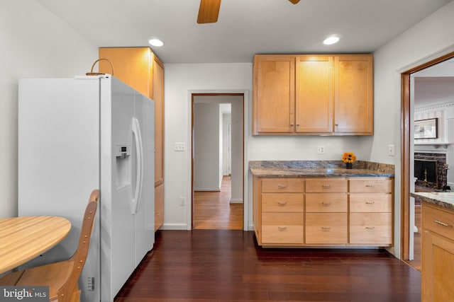 kitchen featuring white fridge with ice dispenser, light brown cabinets, dark wood finished floors, and a ceiling fan