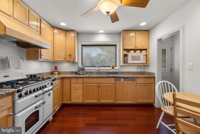 kitchen featuring white microwave, paneled dishwasher, dark wood-type flooring, a sink, and double oven range