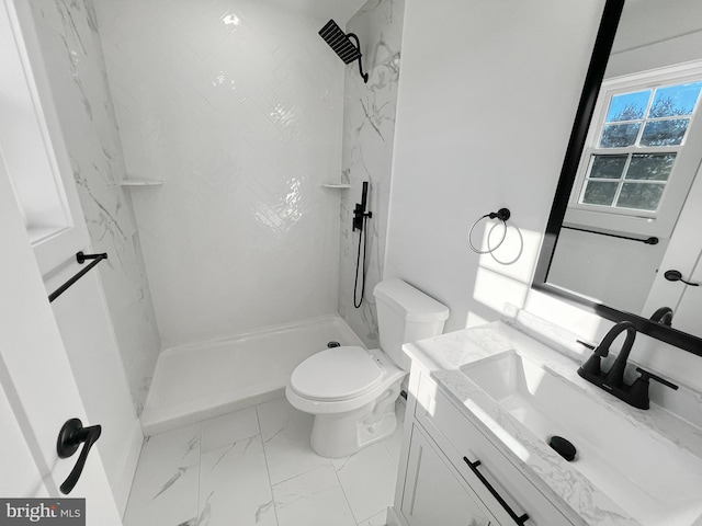 bathroom with walk in shower, vanity, and toilet