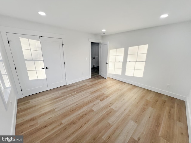 unfurnished bedroom featuring light hardwood / wood-style floors and a closet