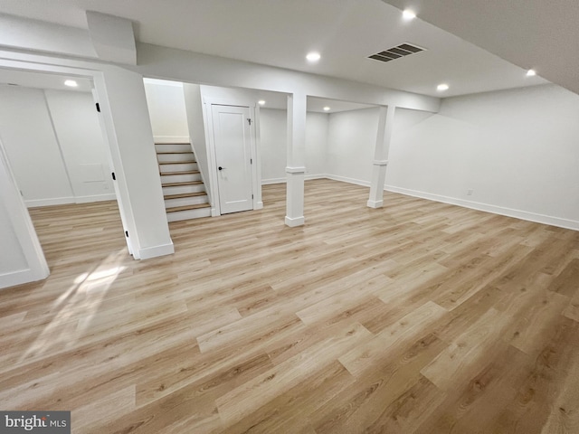 basement with light hardwood / wood-style flooring