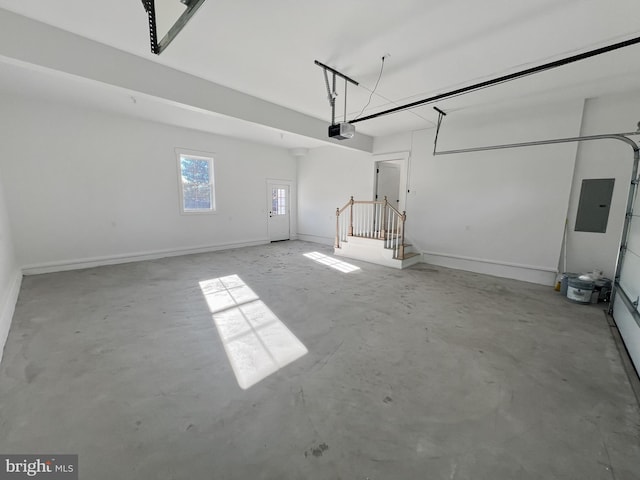 garage featuring a garage door opener and electric panel