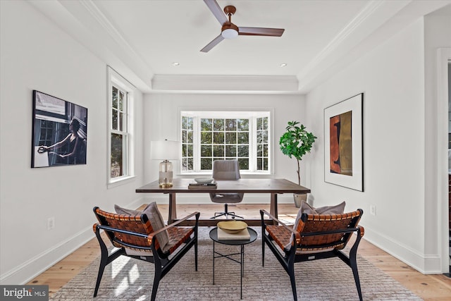 home office featuring baseboards, ceiling fan, crown molding, and light wood finished floors