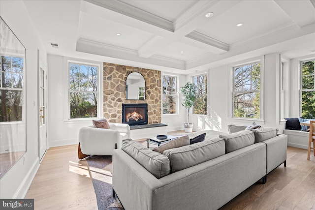 living room featuring beam ceiling, a fireplace, light wood-type flooring, and coffered ceiling