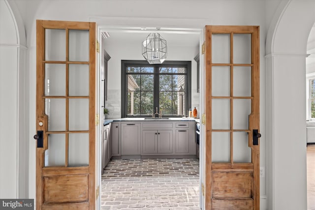 interior space with brick floor and a sink