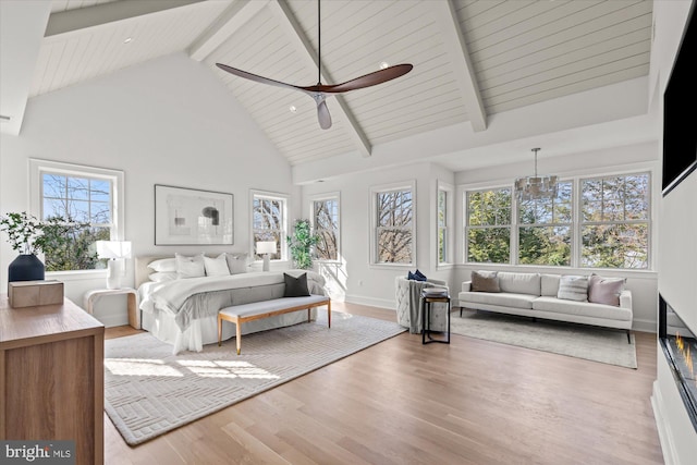 bedroom featuring beam ceiling, high vaulted ceiling, wood finished floors, baseboards, and ceiling fan