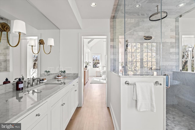 bathroom featuring vanity, a shower stall, recessed lighting, and wood finished floors