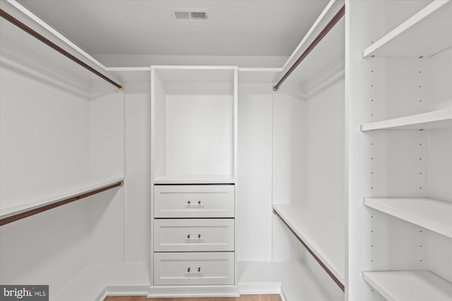 walk in closet with wood finished floors and visible vents