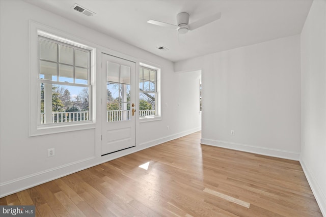 spare room featuring visible vents, ceiling fan, baseboards, and light wood-style floors