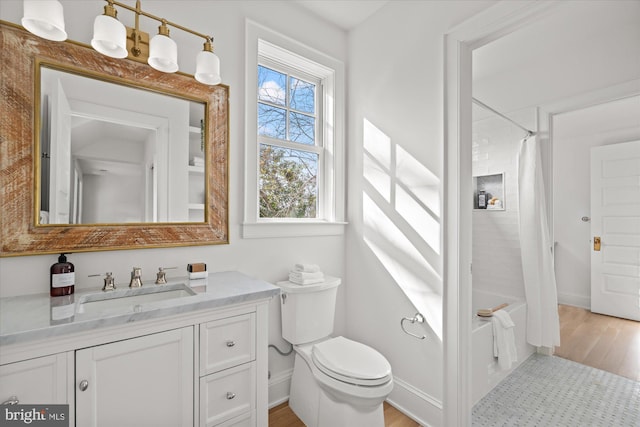 full bathroom with toilet, shower / tub combo with curtain, wood finished floors, baseboards, and vanity