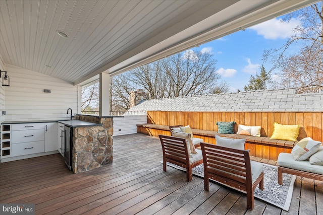 wooden terrace featuring fence and an outdoor hangout area