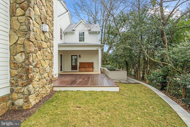 rear view of property featuring a porch, a lawn, and roof with shingles