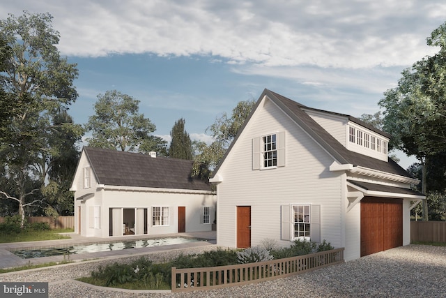 view of front of house featuring an attached garage, driveway, an outdoor structure, and fence