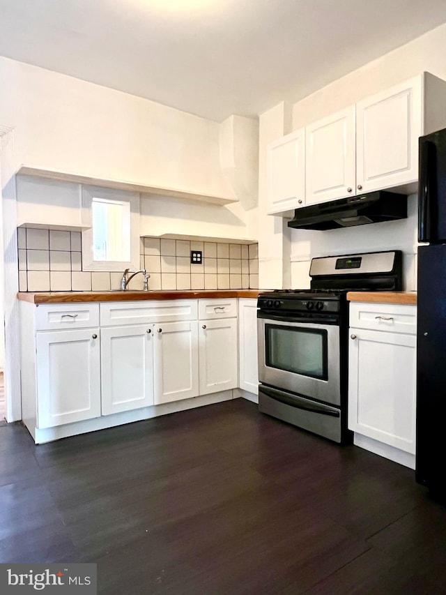 kitchen with black refrigerator, dark wood-type flooring, gas stove, and white cabinets