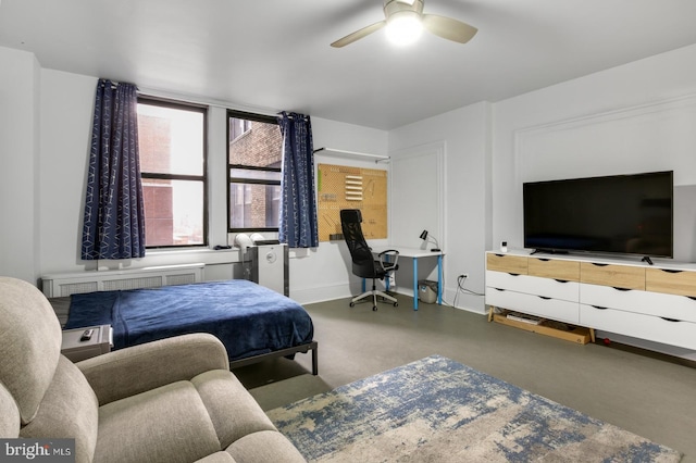 bedroom featuring radiator, concrete floors, and ceiling fan