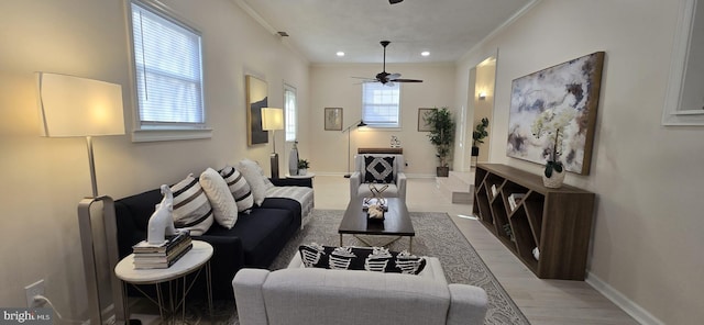 living room featuring ceiling fan, crown molding, a healthy amount of sunlight, and hardwood / wood-style flooring