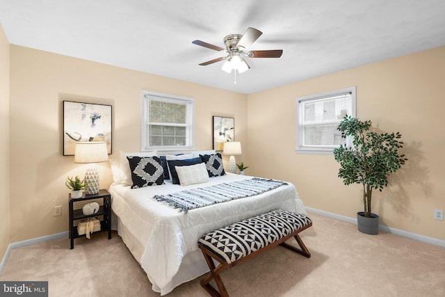 bedroom with ceiling fan and light colored carpet