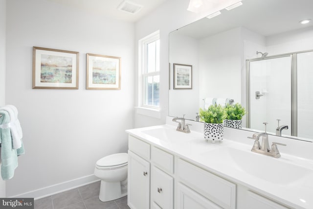 bathroom featuring vanity, toilet, tile patterned flooring, and a shower with door