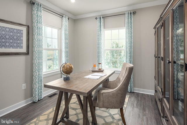 dining room featuring crown molding and dark hardwood / wood-style floors