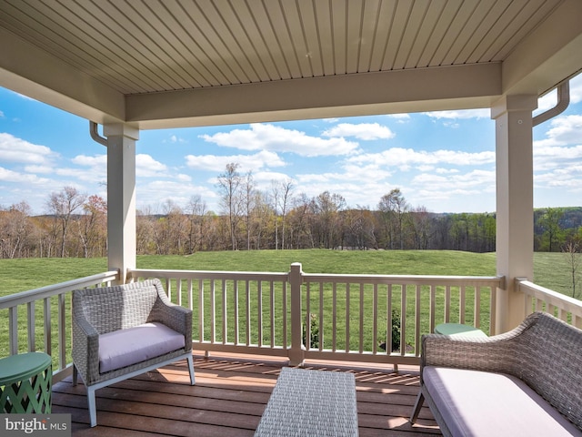 wooden deck featuring a yard